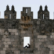 An Israeli soldier sits on guard above the Damascus Gate to the Old City