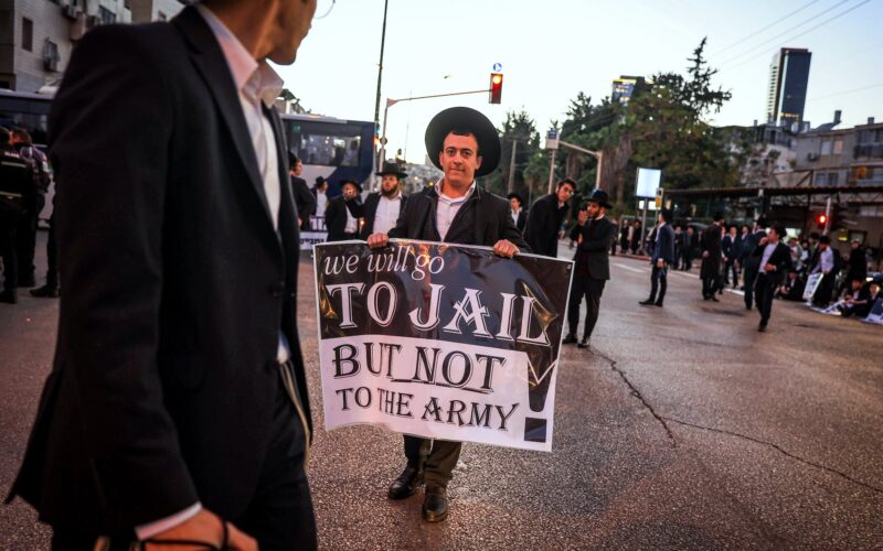 Ultra orthodox Jews block a road during a protest