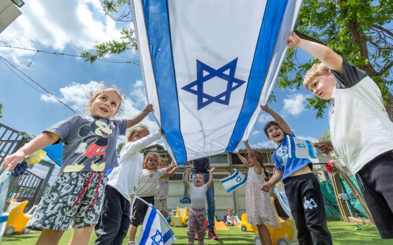 Israeli children play with Israeli flags