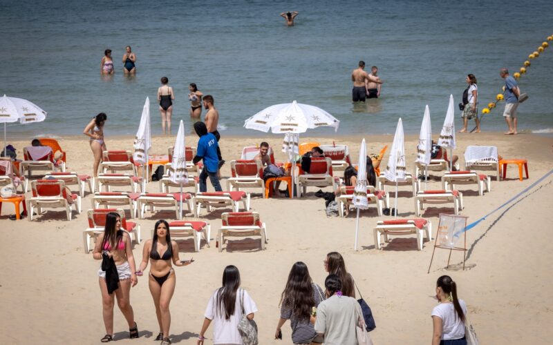 Israelis on the beach in Tel Aviv as a heatwave hits Israel