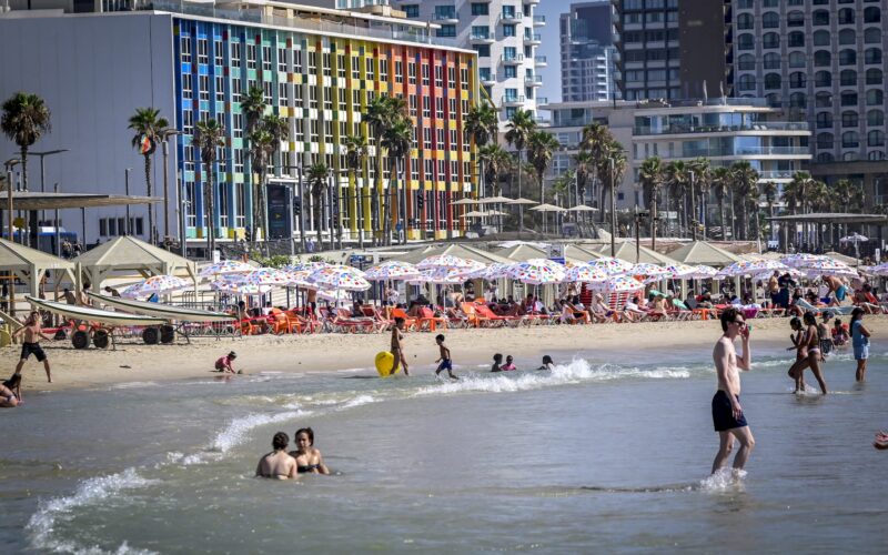 People enjoy the beach in Tel Aviv